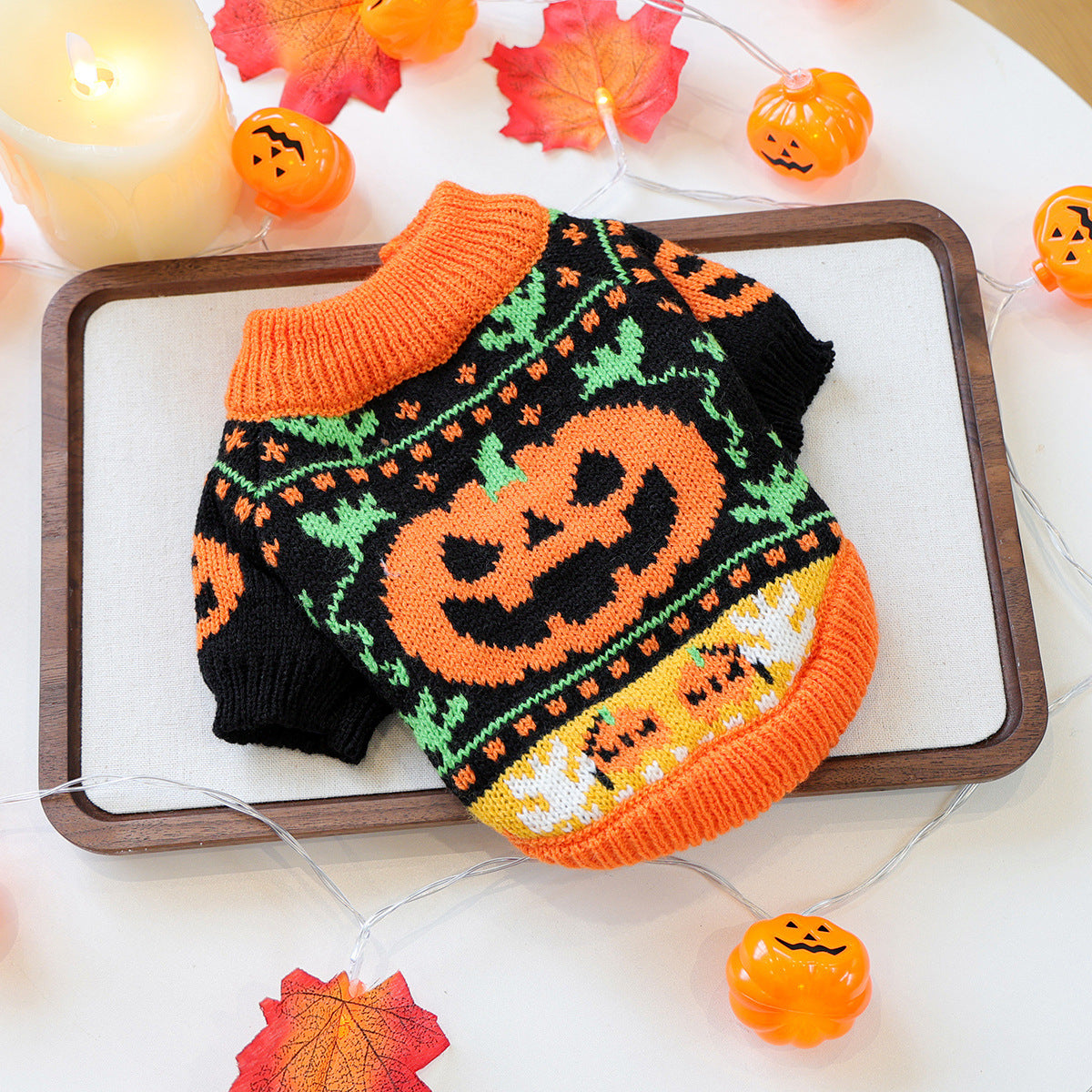 Black and orange pumpkin knit pet sweater laid flat